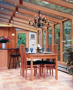 a dining room table with chairs and a chandelier hanging from it's ceiling