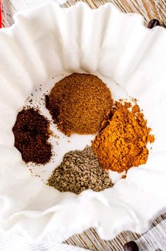 three different types of spices in a paper bowl