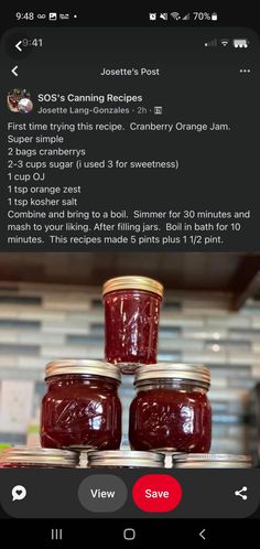 three jars of jam sitting on top of each other in front of a phone screen