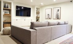 a living room filled with furniture and a flat screen tv mounted on the wall above it