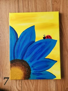 a painting of a blue flower with a ladybug on it