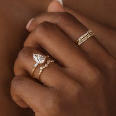 a woman's hand with two rings on her left and one ring on her right