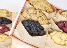 a box filled with assorted cookies sitting next to each other