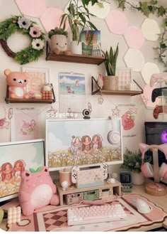 a computer desk topped with lots of pink and white items