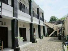 two story white building with black balconies