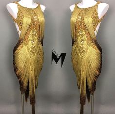 two mannequins are dressed in gold dresses