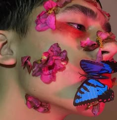 a woman with butterflies on her face and flowers all over her body, covering her eyes