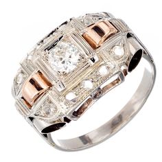 18k white and rose gold engagement ring. Art Deco style band with rose gold half link on either side of center Old European cut diamond. Various sized rose cut diamonds are set a cross band. 1 Old European H SI2 diamonds 4.4 x 2.3 mm Approximate .30 total carat weight 10 rose cut H-I SI2 diamonds 1.5-1.85mm Approximate .19 total carat weight Size 6.75 and sizable 18k white gold 18k rose gold 4.7 Grams Tested: 18k 5.92mm high at top 2.20 wide at bottom Antique Wedding Bands, Diamond Sapphire Engagement Ring, Antique Engagement Rings Vintage, Engagement Ring Art Deco, Antique Bracelets, Vintage Sapphire, Diamond Engagement Rings Vintage, Ring Art Deco, Estilo Art Deco