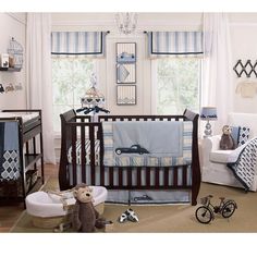 a baby's room is decorated in blue and white