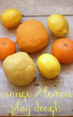 lemons, oranges and lemon play dough on a wooden table with the words orange & lemon play dough