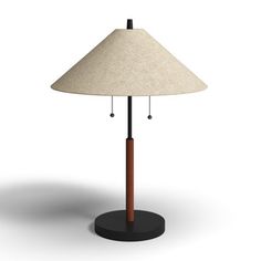 a lamp that is on top of a black base with a white shade over it