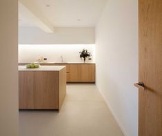 a kitchen with wooden cabinets and white walls