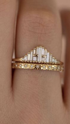 a woman's hand with a yellow and white diamond ring on top of her finger