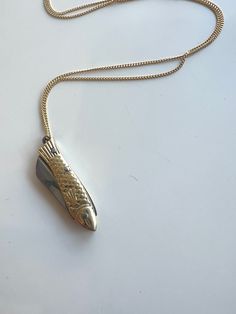 This teeny-tiny pocket knife is one-of-a-kind. Shaped like a sardine, it features a gold and silver design that packs a punch. But don't take it on a plane - just a friendly heads up! Gold: Hanging from a 30" brass chain with an adjustable option so you can wear it shorter with your other favorite necklaces. (Fish measures 1" (folded) and is made from Brass and stainless steel) Silver: Hanging from a 26" stainless steel chain with clasp (not adjustable). Fish measures 1" (folded) and is made fro Sardine Necklace, Fish Necklaces Jewelry, Silver Fish Necklace, Pocket Knife Necklace, Luxury Gold Fish-shaped Necklace, Handmade Silver Fish-shaped Necklace, Knife Necklace, Bar Jewelry, Garden Jewelry