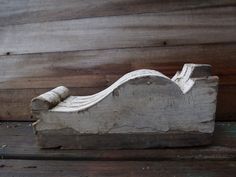 a piece of wood that has been carved to look like a boat on the water