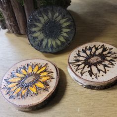 three decorative wooden boxes sitting on top of a table