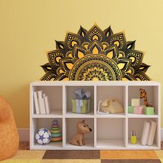 a decorative wall decal in the shape of a sunflower on a book shelf