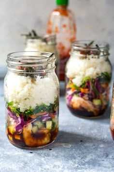 three jars filled with food sitting on top of a table