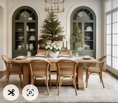 a dining room table with chairs and a christmas tree in the center surrounded by windows