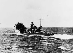 an old photo of a ship in the ocean with another boat nearby on the water