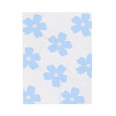 a blue and white flowered napkin on a white tablecloth with pink dots in the middle