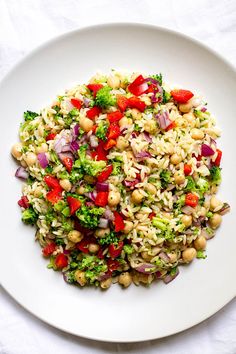 a white plate topped with rice, broccoli and red onion sprouts