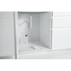 an empty white cabinet with some items in it