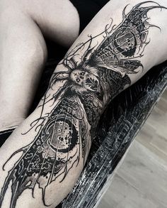 a woman's leg with tattoos on it and an owl in the middle of her legs