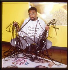 a man sitting on the floor with many wires in front of him and his face