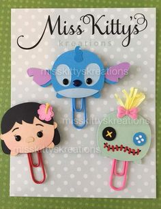 two paper clips with faces on them and the words miss kitty's creations written below