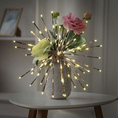 a vase filled with flowers sitting on top of a table