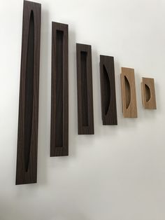 five wooden pieces are arranged on the wall