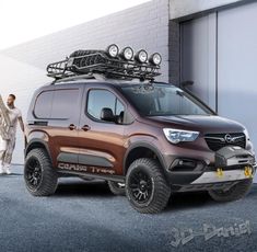 a man standing next to a brown and black truck with skis on it's roof