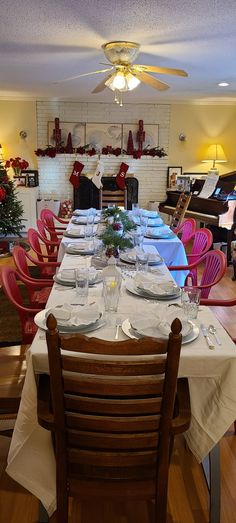 a dining room table is set for christmas dinner