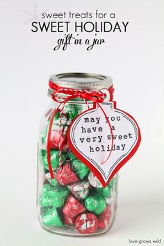 a jar filled with lots of candy sitting on top of a table