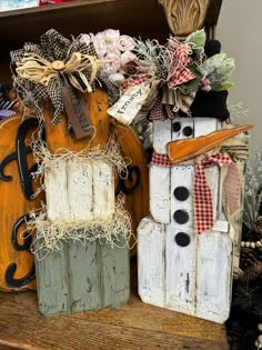 two snowmen made out of wooden crates sitting next to each other on top of a table