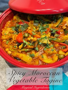 a red bowl filled with vegetables on top of a table