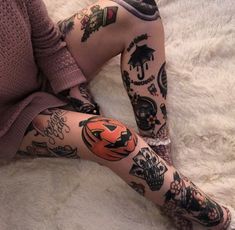 a woman with many tattoos on her legs