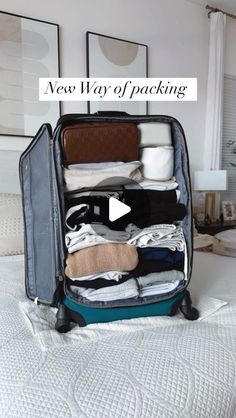 an open suitcase sitting on top of a bed with clothes in it and the words new way of packing