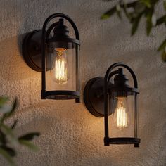 two outdoor lights on the side of a wall