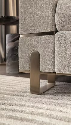 a close up of a metal object on the ground in front of a couch and coffee table