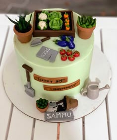 a cake decorated with gardening related items on a table