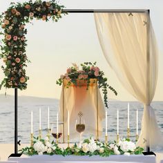 an outdoor wedding setup with candles and flowers