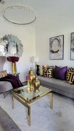 a living room filled with lots of furniture next to a wall mounted mirror and chandelier