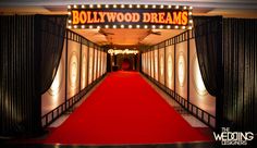 a red carpeted hallway leading up to a sign that says hollywood dreams on it