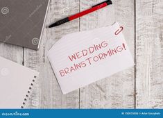 a note with the words wedding brainstorming written on it next to a laptop