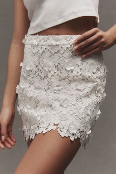 The Cami NYC Ilima Skirt showcases chic floral appliqués that dance along a flirty scalloped silhouette. | Ilima Floral Appliqué Mini Skirt by Cami NYC in White, Women's, Size: 6, Polyester at Anthropologie Chic Lace Mini Skirt, Elegant Fitted Mini Skirt For Wedding, Fitted Floral Embroidered Skirt, Chic Lined Lace Mini Skirt, Chic Lace Lined Mini Skirt, Chic Lace Mini Skirt With Lining, Chic Lace Mini Skirt With Lined Skirt, Elegant Lace Mini Bottoms, Elegant Lace Mini-length Bottoms