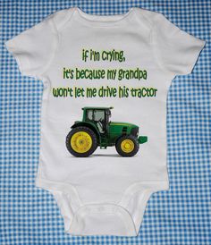 a baby bodysuit with an image of a green tractor on it's chest