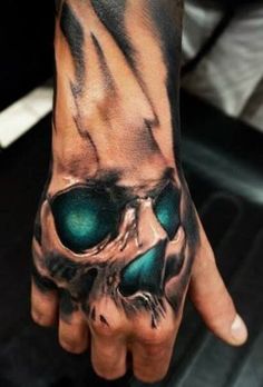 a hand with a skull and green eyes on it