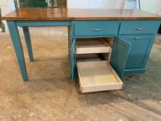 a kitchen island with drawers underneath it